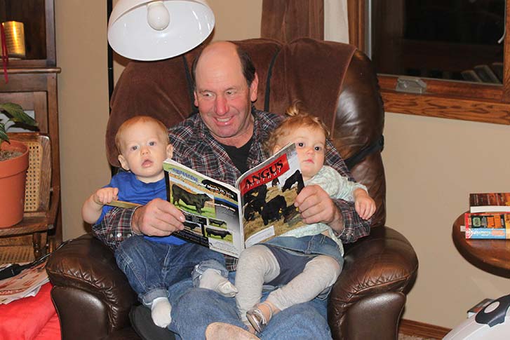 Mark introducing grandchildren, Colin and Summer, to his favorite reading material! ...Breaking em in early!